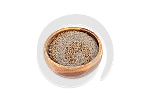 Aromatic cumin seeds in a wooden bowl on a white background.