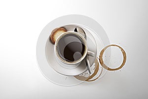 Aromatic cup of Cappuccino coffee, on a saucer, with a spoon, shot from above on white, with a drop shadow