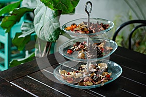 Aromatic dried herbs in a glass tray set in air-conditioned cafe. 3