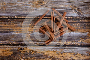 Aromatic dry cinnamon sticks on wooden table background, Top view