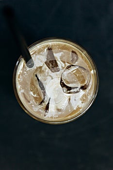 Aromatic fresh iced coffee on a dark background.