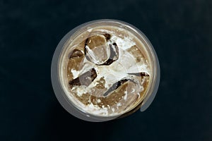 Aromatic fresh iced coffee on a dark background.