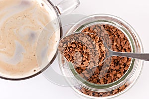 The aromatic granules of instant coffee are in the jar.
