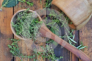 Aromatic herb in a woden spoon and mortar