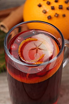 Aromatic mulled wine in glass cup on table, closeup