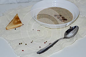 Aromatic mushroom cream soup with champignons. Fresh vegetables and freshly baked bread. A hearty and delicious lunch.