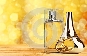 Aromatic perfume bottles on golden background