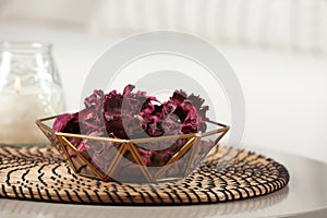 Aromatic potpourri of dried flowers in bowl on white table indoors