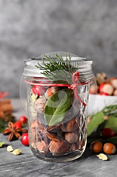 Aromatic potpourri in glass jar on grey table