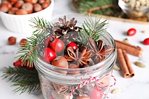 Aromatic potpourri in glass jar on white table, closeup