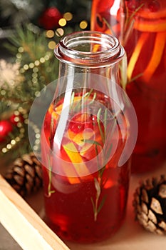 Aromatic punch drink with citrus fruits on table, closeup