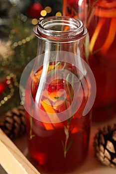 Aromatic punch drink with citrus fruits on table, closeup