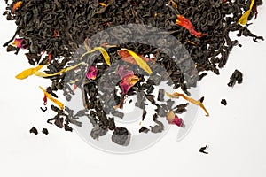 Aromatic, pungent, black tea with dry berries and flowers on white background.