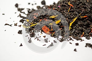 Aromatic, pungent, black tea with dry berries and flowers on white backround.