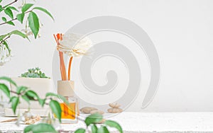 Aromatic reed freshener, Fragrance Diffuser Set of bottle with aroma sticks reed diffusers on white wall background and blurred photo