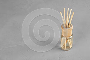 Aromatic reed freshener on grey table