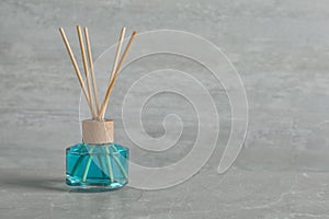 Aromatic reed freshener on grey table