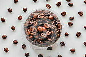 Aromatic roasted coffee beans scattered on a white background