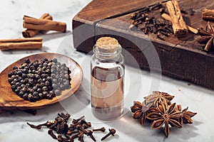 Aromatic seeds essential oil on glass bottle