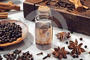 Aromatic seeds essential oil on glass bottle