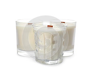 Aromatic soy candles with wooden wicks on white background