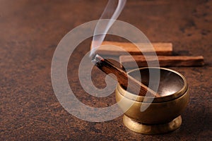 Smoking herbal incense.The smoke of palo santo stick photo