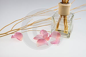 Aromatic sticks with light pink rose and dried wood stick