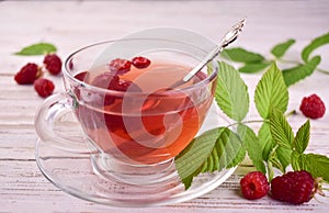 Aromatic tea from raspberries in a cup.Close-up.