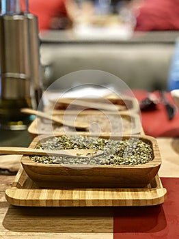Aromatical dry herbs on the wood plate