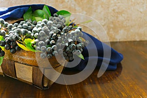 Aronia Aronia melanocarpa in a wicker basket on the table. Useful berry. photo