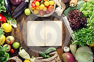 Around empty cookbook set of healthy food on wooden table