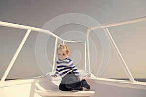 Around world. Child cute sailor on yacht sunny day. Adventure of boy sailor travelling sea. Boy adorable sailor striped