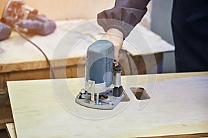 Ð¡arpenter working with milling machine. Joinery, woodworking and furniture making, professional carpenter cutting wood in