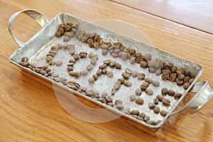 Arrange coffee beans to make the word coffee