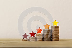 Arrange five star shape on rows of rising coins on table. Business success, new challenge, new opportunity concept : The best