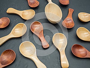 Arranged assorted wooden teaspoons on slate