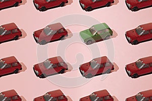 Arranged old toy Serbian small car. Maroon and green color. Peeled paint. Minimal design on pink background. Pattern