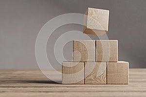 Arranged wood cube stacking as shape, mock up for create symbol, business growth and management concept