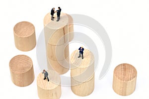 Arranged Wood Cylinder and Businessman on white background.