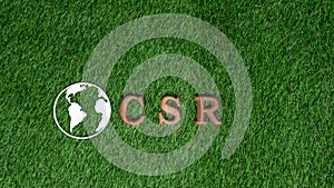 Arranged wooden alphabet text in CSR on biophilic background. Gyre