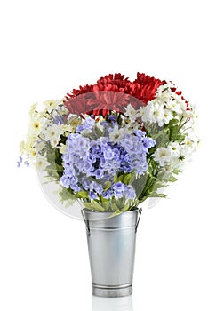 arrangement of artificial flowers in metal pot