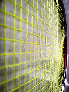 The arrangement of badminton racket strings is yellowish green