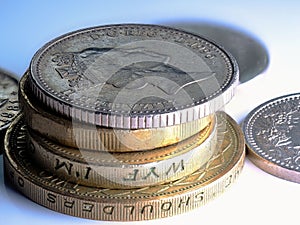Arrangement of coins in a stack on a white surface