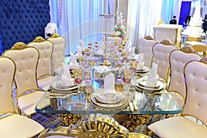 Arrangement of an elegant wedding party table in a special events ballroom.