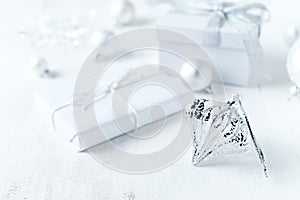 An arrangement of gift boxes and Christmas decorations on white background. Symbolic image. Close up. Copy space