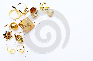 An arrangement of golden Christmas decorations on white background. Flatlay. Copy space