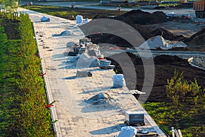 arrangement of a green recreation area, preparation for laying cable lighting, landscaping and laying tiles on paths