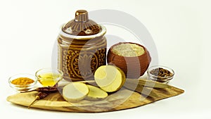 Arrangement of  Indian raw spices on colouful mini clay pots on a wooden base