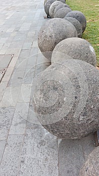 arrangement of large round stones lined up alternately in a courtyard of the old city of Jakarta