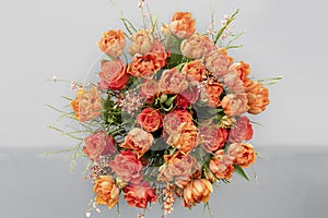 Orange tulips, roses, broom in spring flowers bouquet. Spring dream with beautiful filled orange yellow tulips, top view.